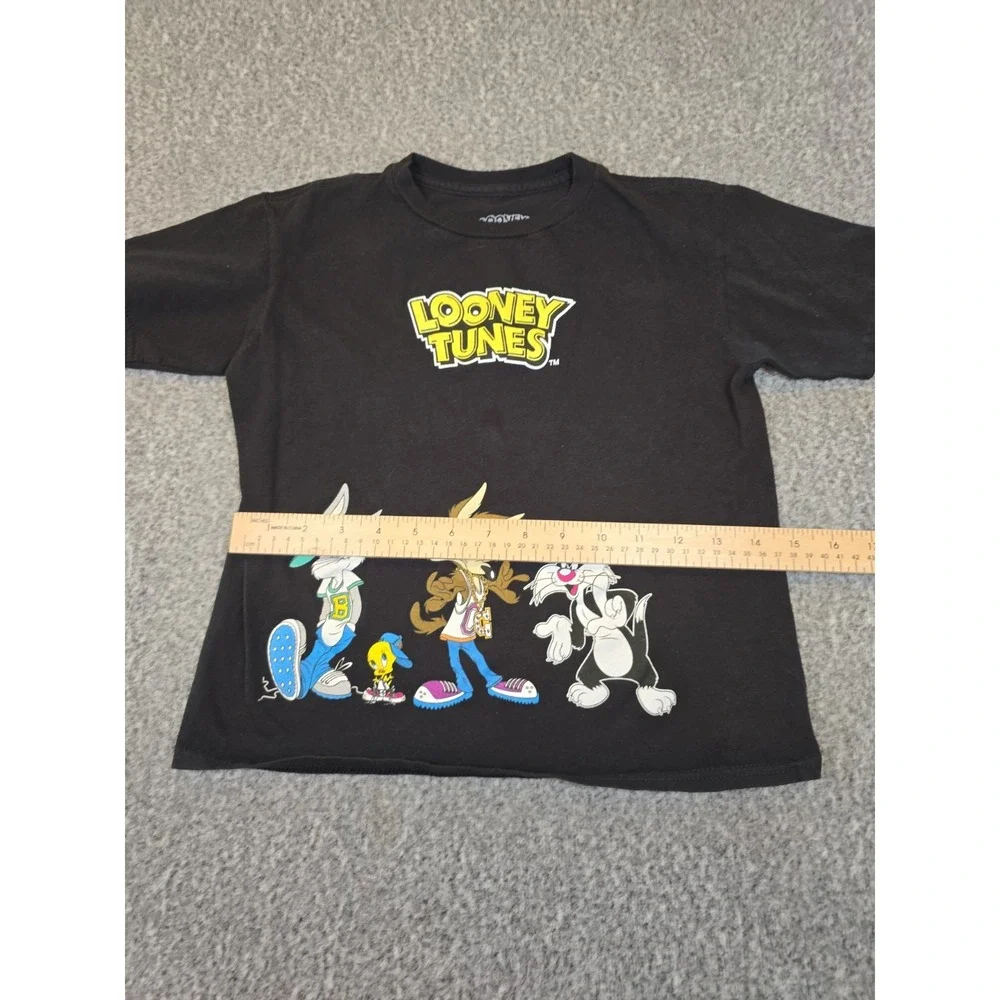 black Looney Tunes t-shirt features a graphic of Bugs Bunny, Wile E. Coyote,...